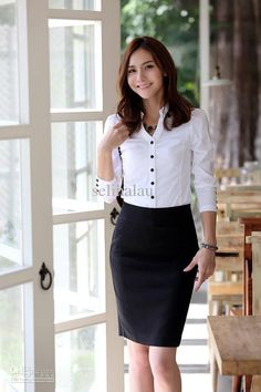 A woman wearing a white shirt with a black skirt